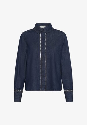 Mörkblå denimskjorta med krage, med en framknäppning prydd med silvernitar och nitade ärmslut. Långa ärmar med knäppte ärmslut.