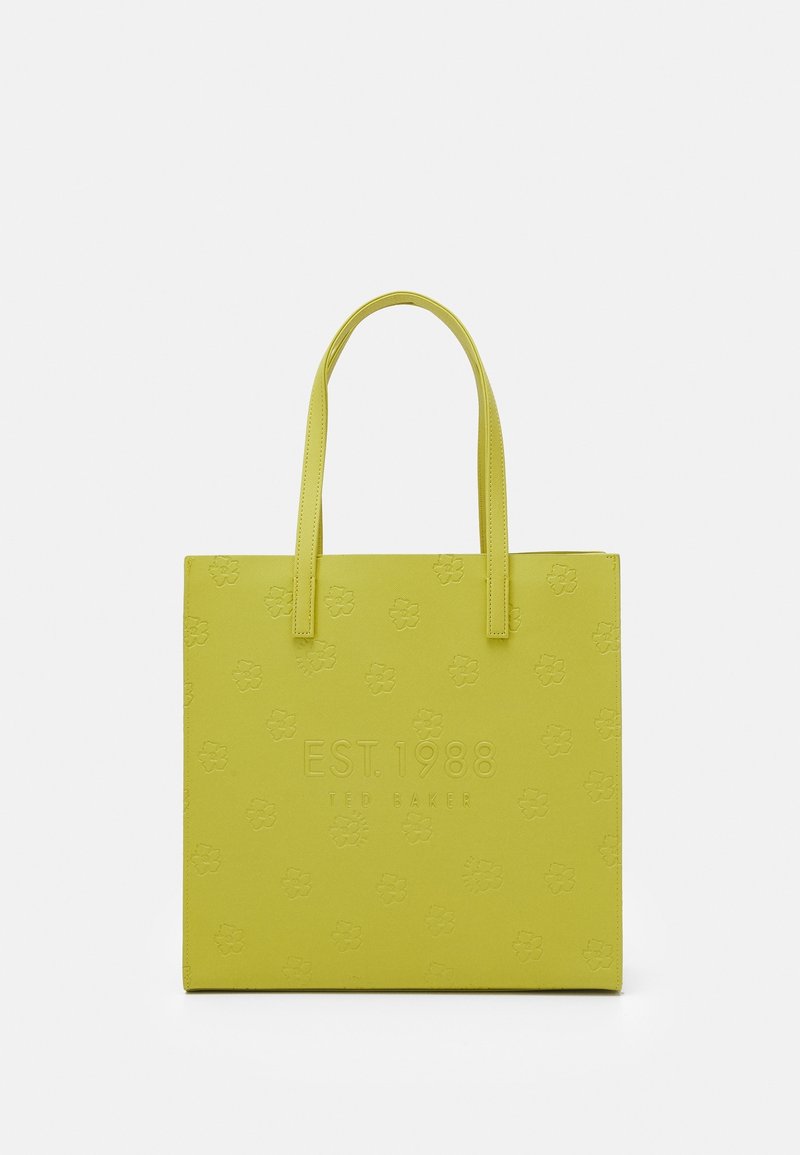 Sac fourre-tout carré jaune avec deux poignées, motifs floraux en relief et texte "EST. 1988 TED BAKER" sur le devant.