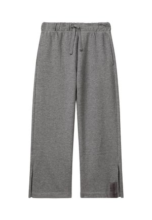 Pantaloni ampi grigi in felpa con vita elastica, coulisse, tasche laterali, piccole fessure laterali e etichetta "DREAM" vicino all'orlo.