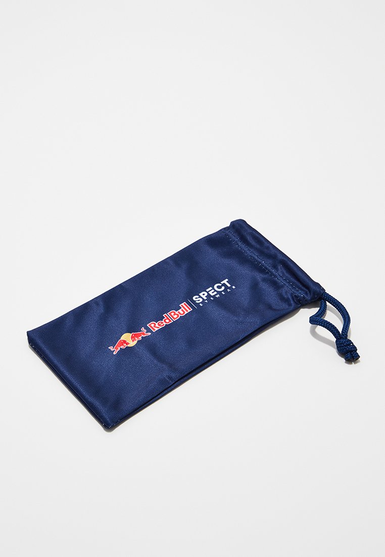 Granatowa sakwa ze sznureczkiem wykonana z satynowego materiału, z logo Red Bull i napisem "SPECT" w kolorze białym. Gładka tekstura, prostokątny kształt.