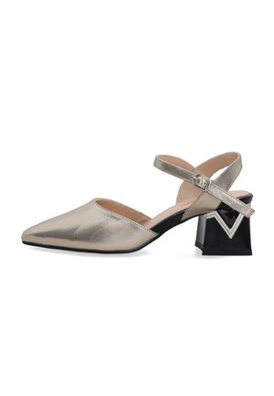 Metallic gold pointed-toe shoe with an ankle strap and unique black block heel featuring a decorative silver accent. Smooth texture.