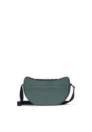 Small green crescent-shaped crossbody bag with black adjustable strap and zipper closure on plain white background.