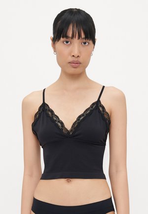 Schwarzes Bralette mit V-Ausschnitt und aufwändigen Spitzenbesätzen, aus weichem Stoff mit einem enganliegenden, cropped Design. Verstellbare Träger.