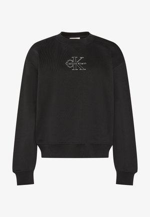 Melns garām piedurknēm džemperis ar apaļu kaklu un baltu Calvin Klein "CK" logotipu krūšu vidū, ar ribotām aprocēm un apakšu.