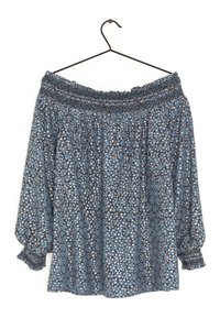 Schulterfreies, langärmliges Blusenshirt in Blau mit floralen Muster. Merkmale sind ein geraffter Halsausschnitt und geraffte Manschetten. Leichtes Material.