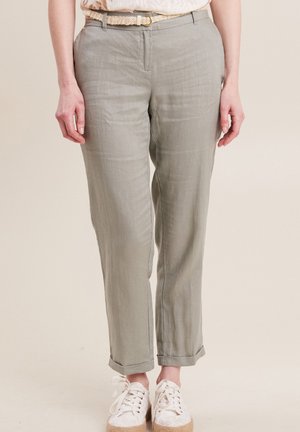 Light gray linen pants with a relaxed fit, featuring a turned-up hem and two front pockets, paired with white lace-up sneakers.