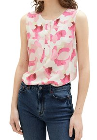 Débardeur en tissu léger avec un motif abstrait rose sur fond blanc. Plis subtils à l'avant, encolure ronde.