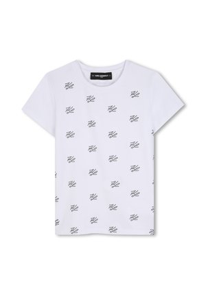 T-shirt blanc à manches courtes avec col rond, avec de petits motifs noirs en points formant des logos abstraits sur toute la partie avant.
