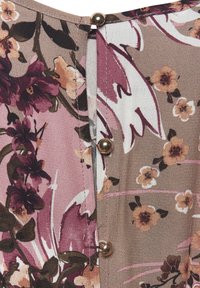 Floral blouse featuring a light brown fabric with pink, purple, and cream flowers, accented by a row of metallic buttons along the closure.