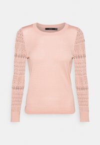Light pink long-sleeve knit top with round neckline and lace-patterned sheer sleeves, fitted body, and ribbed cuffs.