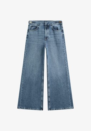Weit geschnittene blaue Jeans aus Denim mit mittlerer Waschung, ausgestattet mit zwei Vordertaschen, einem Reißverschluss und einer geraden Silhouette. Schlichte Nahtdetails.