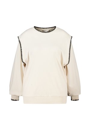 Crèmekleurige sweatshirt met lange mouwen, zwarte zigzagbies op de schouders, halslijn en manchetten, met een losse pasvorm en geribde zoom.