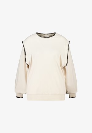 Crèmekleurige sweatshirt met lange mouwen, zwarte zigzagbies op de schouders, halslijn en manchetten, met een losse pasvorm en geribde zoom.