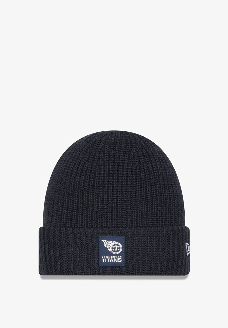 Navy knitted beanie with a folded cuff. Features a rectangular blue patch displaying the Tennessee Titans logo and text. Soft texture.