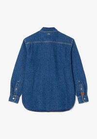 Denim shirt in dark blue, featuring long sleeves, button closures on cuffs, and a curved hem. Lacoste logo on the back near the collar.