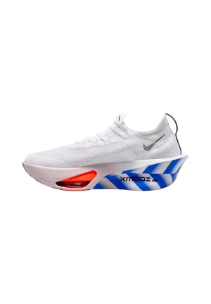 White athletic shoe with knit upper, black Nike swoosh, thick exaggerated white sole with blue diagonal stripes and red air cushioning near toe.