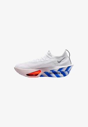 White athletic shoe with knit upper, black Nike swoosh, thick exaggerated white sole with blue diagonal stripes and red air cushioning near toe.