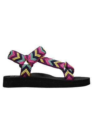 Sandalias tejidas coloridas con un patrón en zigzag en rosa, verde azulado y amarillo, con una suela negra texturizada y tiras anudadas.
