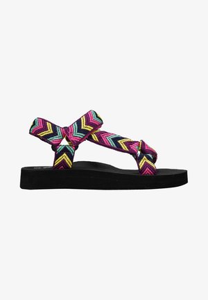 Sandalias tejidas coloridas con un patrón en zigzag en rosa, verde azulado y amarillo, con una suela negra texturizada y tiras anudadas.