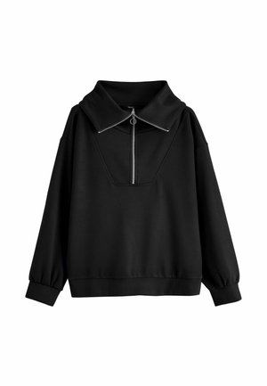 Schwarzer Langarmpullover mit weitem Kragen und silbernem Reißverschluss vorne mit rundem Zieh-Anhänger.