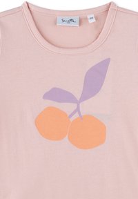Light pink short-sleeve shirt with a round neckline featuring a graphic of two orange circles and a purple leaf design. Soft fabric texture.