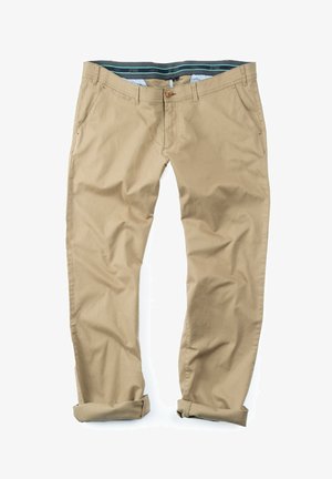 Beige bomuldsbukser med opsmøg, der har en knaplukning og en kontrastfarvet grøn indvendig talje med et subtilt mønster.