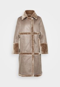 Beige shearling coat with a structured design. Features a collared neckline, wide sleeves, and dual side pockets. Textured exterior with soft trim.
