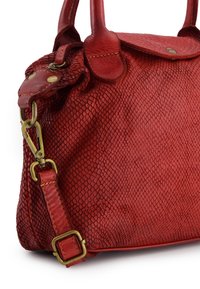 Red leather handbag with a textured, snake skin pattern. Features sturdy handles, a detachable strap, and brass hardware accents.