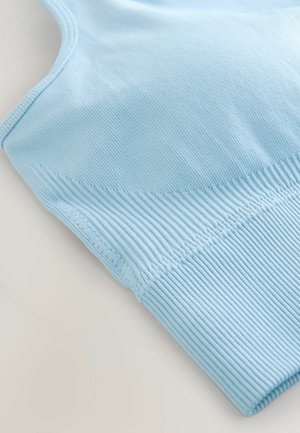 Light blue sports bra with a smooth fabric, ribbed texture on the band, and flat seams for comfort. Adjustable straps enhance fit.