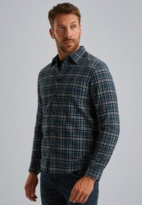 Blauw en groen geruit overhemd met lange mouwen, knoopsluiting en een kraag. De stof lijkt zacht met een zichtbaar ruitpatroon.