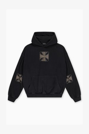 Čierna mikina s kapucňou s veľkým vyšívaným motívom kríža na prednej strane a menšími verziami na oboch rukávoch. Na prednej strane je kapsa typu klokanieho vrecka.