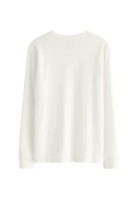 Witte katoenen blouse met lange mouwen en een geribbelde textuur, ronde hals en zonder grafische elementen. Heeft een rechte zoom en manchetten aan de mouwen.