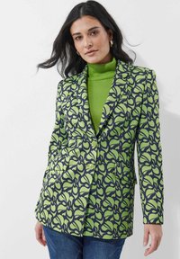 Gevoerd colbert met groene bloemenpatronen op een donkere marine achtergrond, met een voorzijde met twee knopen, revers en zijzakken.