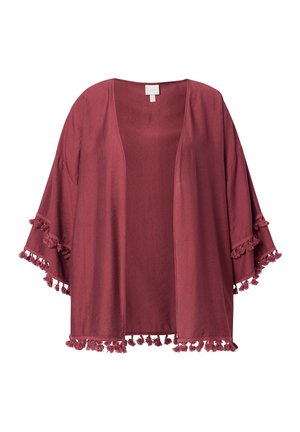 Avoimelta etuosaltaan vaaleanpunainen kimono-takki, jossa on leveät hihat ja tupsukoristeet reunoilla ja kalvosimissa.