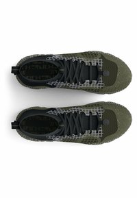 Olive green and black sneakers with a textured mesh upper, gray lace grid, and reinforced toe. Features a pull tab and patterned interior.