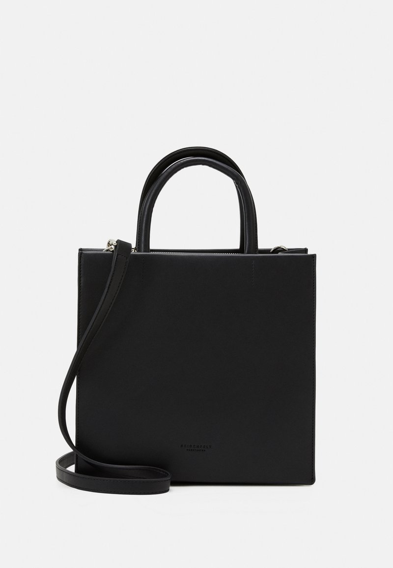 Black leather tote bag with two rounded handles and a detachable shoulder strap. Features a minimalistic design and a smooth texture.