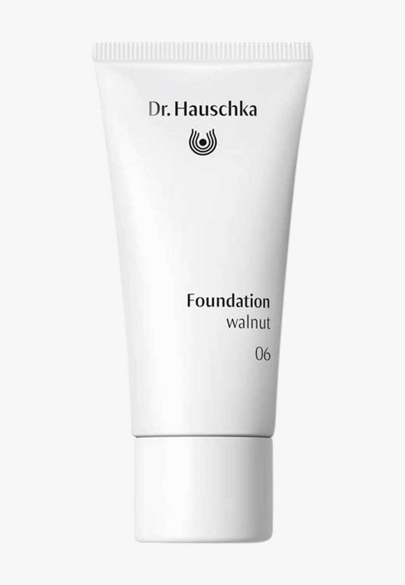 Tube de maquillage fondation Dr. Hauschka en teinte noyer (06) avec un emballage blanc et un texte noir sur un fond uni.