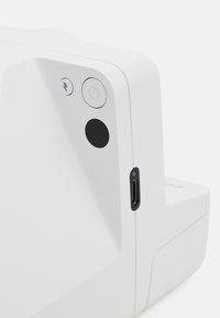 White device with rounded edges features a power button, a black circular button, and a USB-C port. Smooth texture and minimalist design.