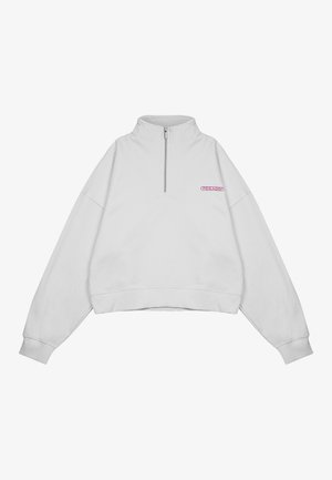 Biała, krótka bluza z suwakiem na pół długości, prążkowanymi mankietami i haftowanym różowym logo na piersi. Wykonana z miękkiego materiału bawełnianego.