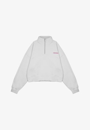 Biała, krótka bluza z suwakiem na pół długości, prążkowanymi mankietami i haftowanym różowym logo na piersi. Wykonana z miękkiego materiału bawełnianego.