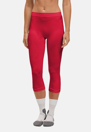 Rote sportliche Capri-Leggings mit strukturierten Einsätzen und einer glatten Oberfläche. Hat einen hohen Bund und sitzt über den Knöcheln.