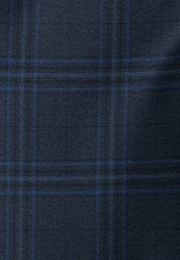 Dark blue plaid fabric featuring a textured weave with lighter blue lines intersecting to form a check pattern.