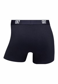 Black cotton boxer shorts with an elastic waistband featuring white "CR7" branding. Smooth texture, fitted design, and mid-thigh length.