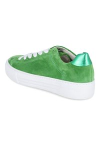 Green suede sneaker with white rubber sole, white laces, and a shiny green accent on the heel. Slightly rounded toe with stitched detailing.