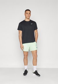 Nike Performance SECONDSUNRISE - Kurze Sporthose - vapor green/black