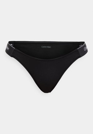 Crne ženske bikini gaćice s glatkom teksturom, dizajnom niskog struka i pojasom s logotipom "Calvin Klein" u bijeloj boji.