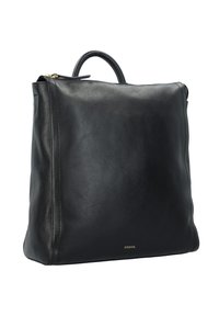 Sac cabas en cuir noir à texture lisse, design minimaliste, poignée supérieure et détail en métal doré avec le nom de la marque "Fossil".