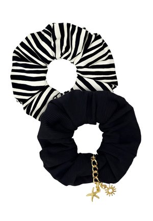 Dwa materiałowe gumki do włosów, jedna czarna z złotymi zawieszkami w kształcie słońca i rozgwiazdy, druga w zebrowe czarno-białe paski.