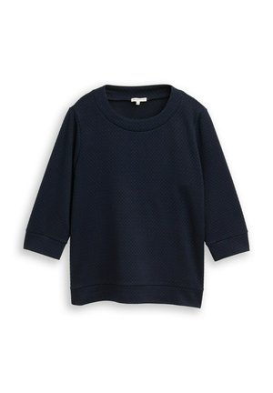 Pull en maille bleu marine, à col rond et à manches trois-quarts. L'ourlet est droit avec une légère chute à l'arrière.