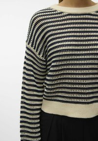 Gestreepte gebreide trui met afwisselend marineblauwe en roomkleurige tinten, geribbelde halslijn, open geweven textuur en cropped ontwerp.